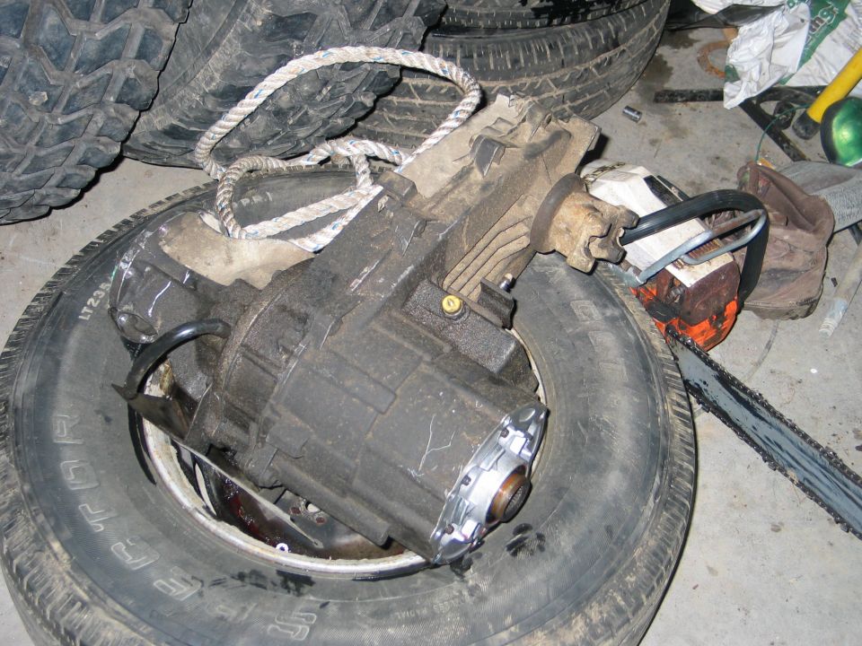 Transfer case on a tire with a chainsaw nearby