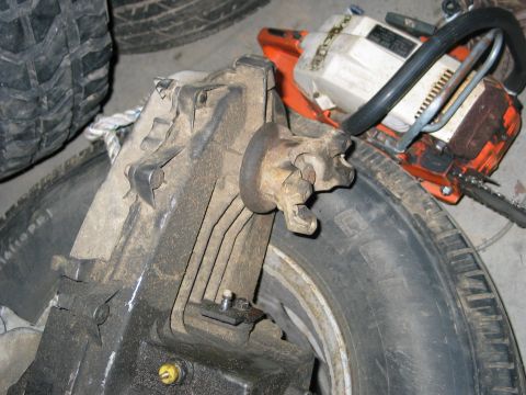 1984 Ford Bronco - Transfer case assembly and chainsaw on tires. Supermotors.net watermark visible.
