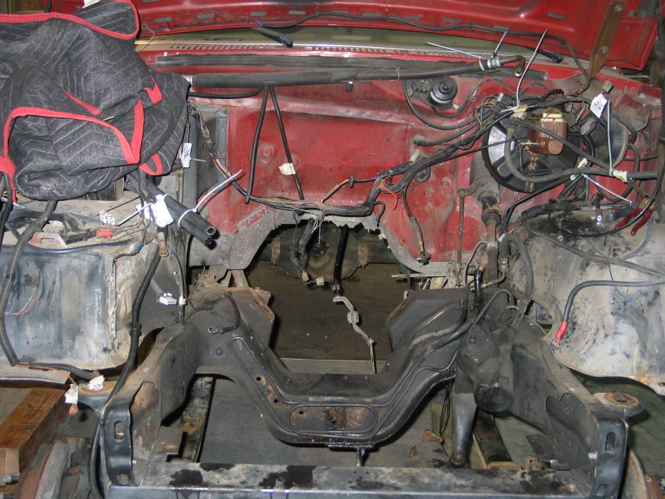 Engine bay with wiring harness and frame components visible