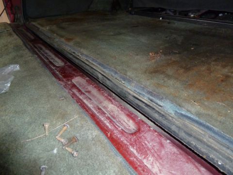 1993 Ford C-150 (Centurion Conversions) - Close-up view of the interior door sill area, showing worn carpet and trim.
