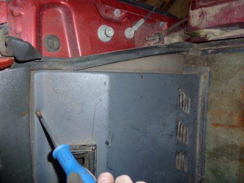 1993 Ford C-150 (Centurion Conversions) - Working on a gray interior panel, a screwdriver is visible removing a screw.