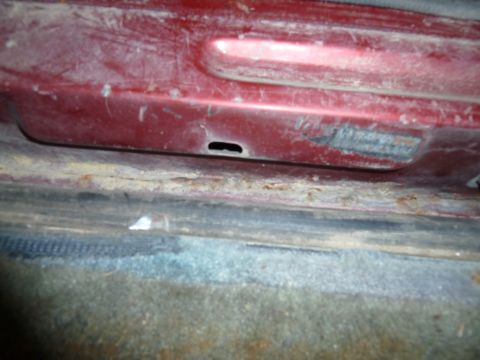1993 Ford C-150 (Centurion Conversions) - Close-up view of the interior door sill, showing wear and tear.