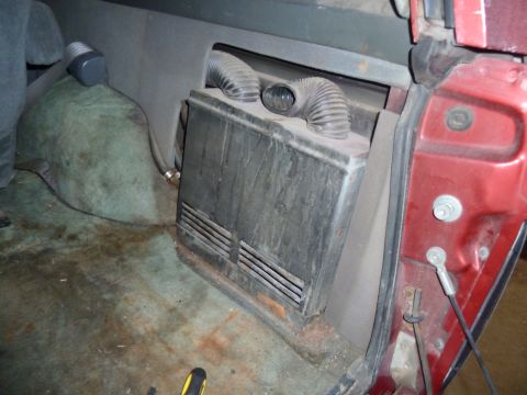 1993 Ford C-150 (Centurion Conversions) - Close-up of an interior heater unit with flexible ducts, showing the rear passenger compartment.