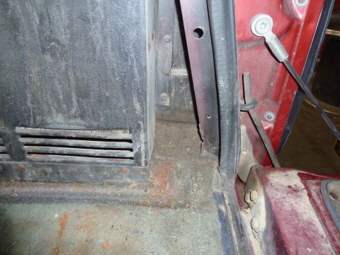 1993 Ford C-150 (Centurion Conversions) - The interior floor and door jamb of a vehicle show signs of wear and dust.