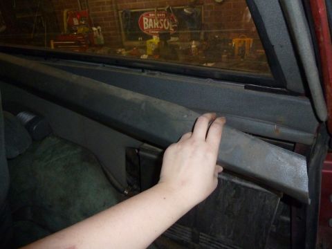 1993 Ford C-150 (Centurion Conversions) - A hand reaches for an interior trim panel, revealing the inside of a vehicle.