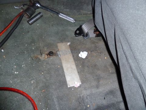 1993 Ford C-150 (Centurion Conversions) - Tools and debris are scattered on the carpeted floor of a vehicle's interior.