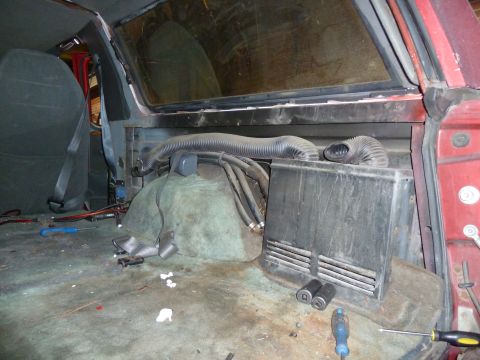 1993 Ford C-150 (Centurion Conversions) - The interior of the vehicle shows exposed ductwork and various components on the floor.