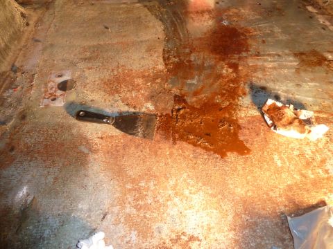 1993 Ford C-150 (Centurion Conversions) - Scraping away rust and debris from a vehicle's interior floor.