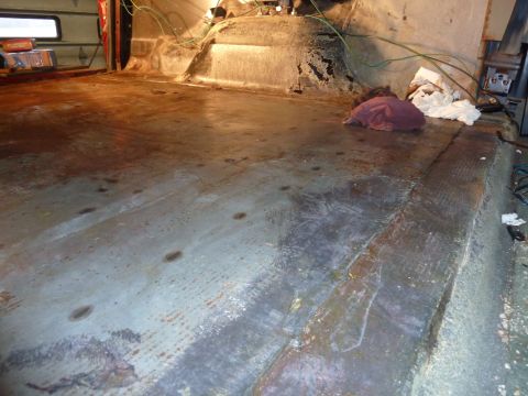 1993 Ford C-150 (Centurion Conversions) - The floor of the vehicle interior shows signs of wear, rust, and some discarded items.