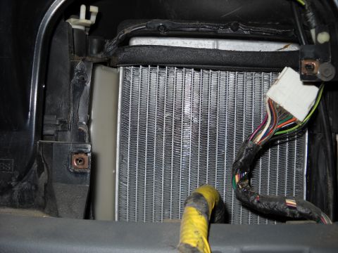 1993 Ford C-150 (Centurion Conversions) - Close-up view of a vehicle's heater core assembly, showing the radiator fins and electrical connections.