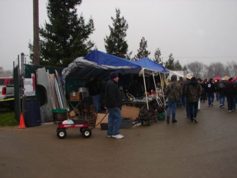 1973 Ford Ranchero - Vendors display goods under tarps at an outdoor market on a cloudy day.