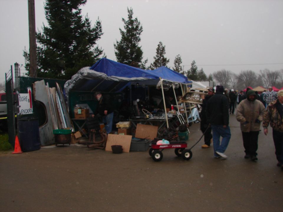 Swap meet vendor booth with tarp on an overcast day