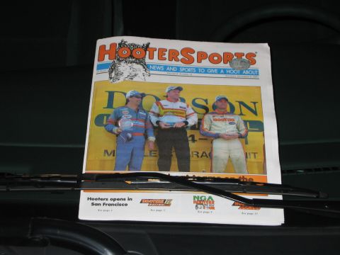 2002 Ford Taurus - A newspaper titled Hooters Sports is displayed on a dashboard, showing three race car drivers.
