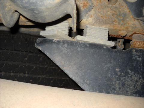 1993 Ford C-150 (Centurion Conversions) - Undercarriage view shows a spare tire and a bumper component with rubber blocks mounted to the frame.