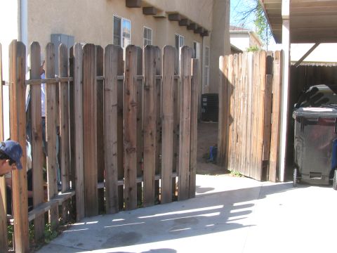 1968 Ford Mustang - A view of a backyard scene a wooden fence and a large trash bin.