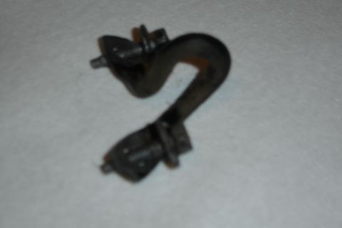 1996 Ford Bronco - A close-up view of a metal torsion bar mounting bracket with bolts attached.