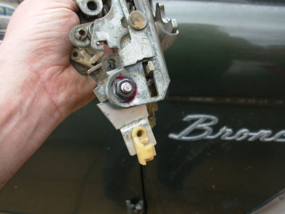 A new lever was cut from a steel plate and drilled for the pivot & operating rod.  A short sleeve was used to prevent the bolt from clamping the levers.  The new lever is adjustable by cutting its notch lower.  It isn't attached to the original lever so that the catch can move normally, without forcing the inside handle.  But the inside handle will now operate the catch at all times, regardless of the condition of the other levers, or the position of the lock.

After some testing, the nut was found to interfere slightly with the lock slide (the boot-shaped part), so the bolt was reversed.