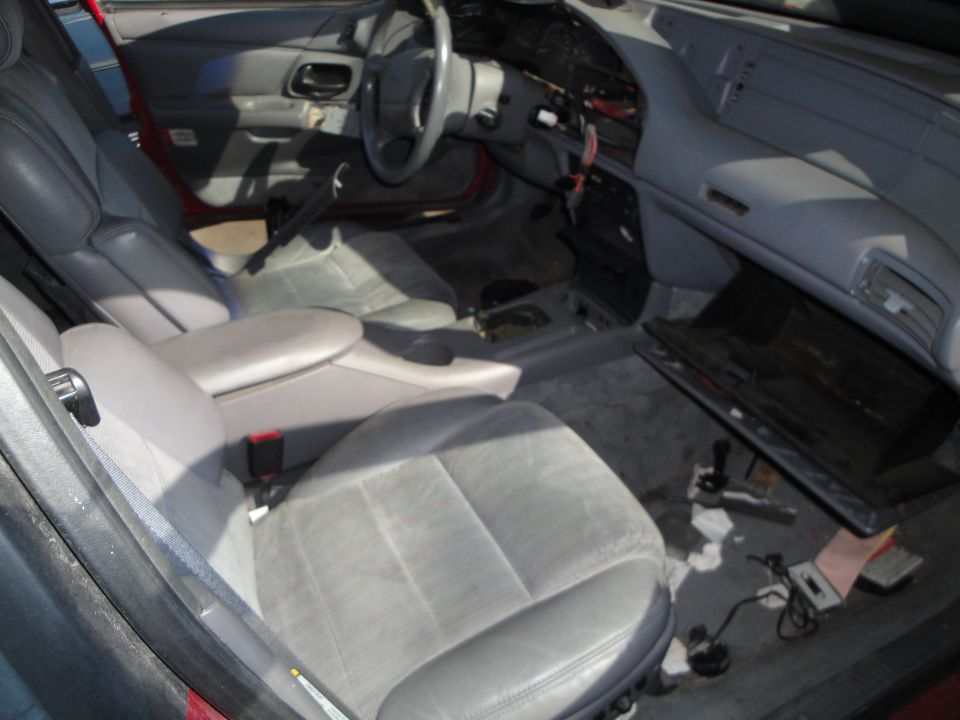 Interior of a 1993 Ford Taurus showing gray seats and dashboard