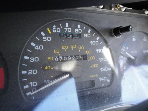 1993 Ford Taurus - Close-up of a car's instrument cluster, displaying speed, mileage, fuel, and temperature readings.
