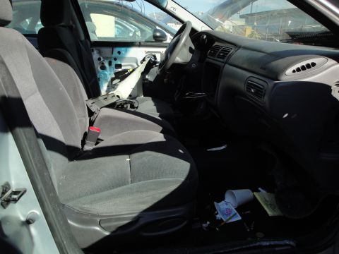 1993 Ford Taurus - Interior view of a 1993 Ford Taurus with a removed door panel and debris scattered on the floor.