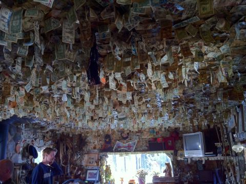 1989 Ford Bronco - The interior of a room is covered in hanging dollar bills, creating a unique and cluttered atmosphere.