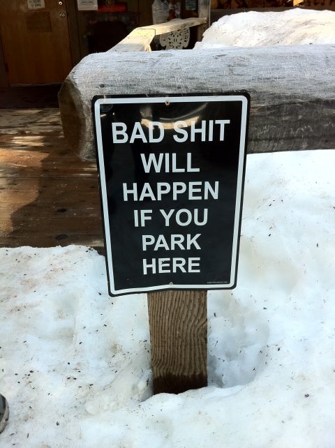 1989 Ford Bronco - A warning sign is posted in the snow, indicating severe consequences for parking in the area.