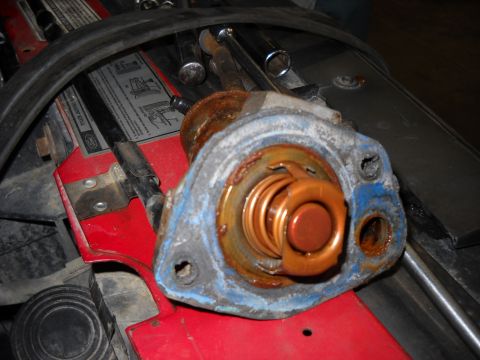 1993 Ford C-150 (Centurion Conversions) - A corroded thermostat housing is shown, indicating a need for replacement.