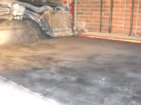 1993 Ford C-150 (Centurion Conversions) - The interior cargo area shows exposed ductwork and a black floor, with a brick wall visible in the background.