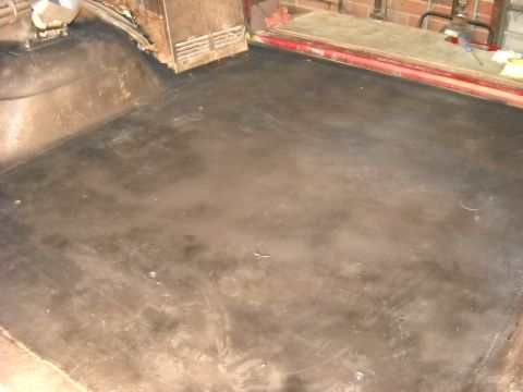 1993 Ford C-150 (Centurion Conversions) - The interior floor of a vehicle, possibly a van or truck, is visible in this photograph.