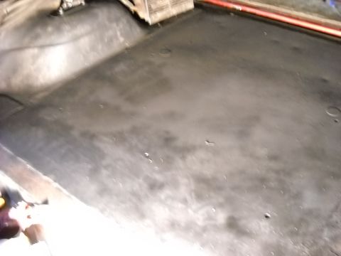1993 Ford C-150 (Centurion Conversions) - The floor of a vehicle interior shows wear and some discoloration.