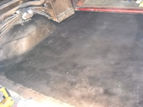 1993 Ford C-150 (Centurion Conversions) - The dark floor area of a vehicle's interior is visible, with some electrical components and wiring in the background.