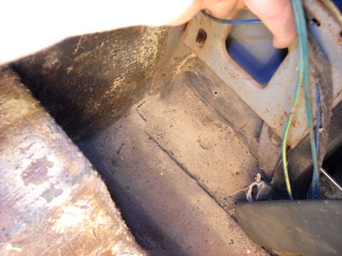 1993 Ford C-150 (Centurion Conversions) - Close-up of the interior floor pan and wiring harness, showing wear and tear.