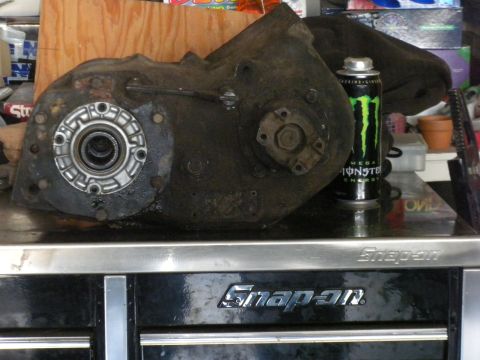 1989 Ford Bronco - A transfer case sits on a toolbox, next to a can of Monster Energy drink.