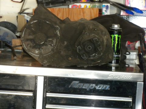 1989 Ford Bronco - A dirty transfer case sits on a tool chest, with a Monster Energy drink can nearby.