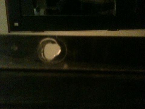 1993 Ford Bronco - Detail of a vehicle bumper, showing a circular opening with a white component.