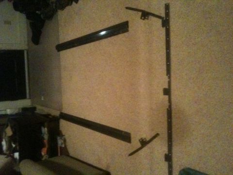 1993 Ford Bronco - Several black car parts are mounted on a wall, possibly for display or storage.
