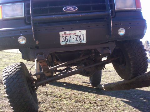 1988 Ford Bronco - Front view of a 1988 Ford Bronco, showing off-road suspension and grille details.