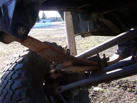 1988 Ford Bronco - Undercarriage view shows suspension components, including leaf springs and a shock absorber.