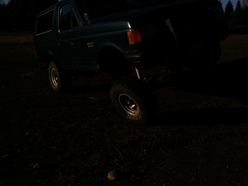 Green Ford Bronco lifted on off-road tires