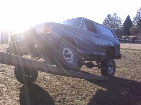 1988 Ford Bronco - This 1988 Ford Bronco is shown with a lifted suspension, balancing on a log.