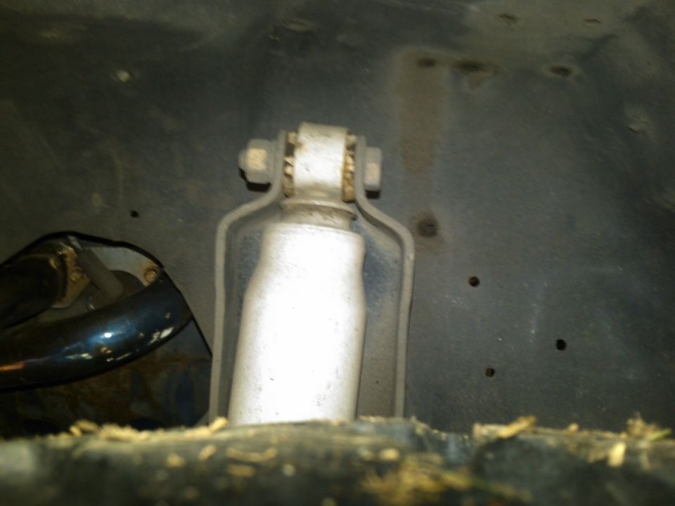 close-up of a vehicle's rear shock absorber and mounting bracket