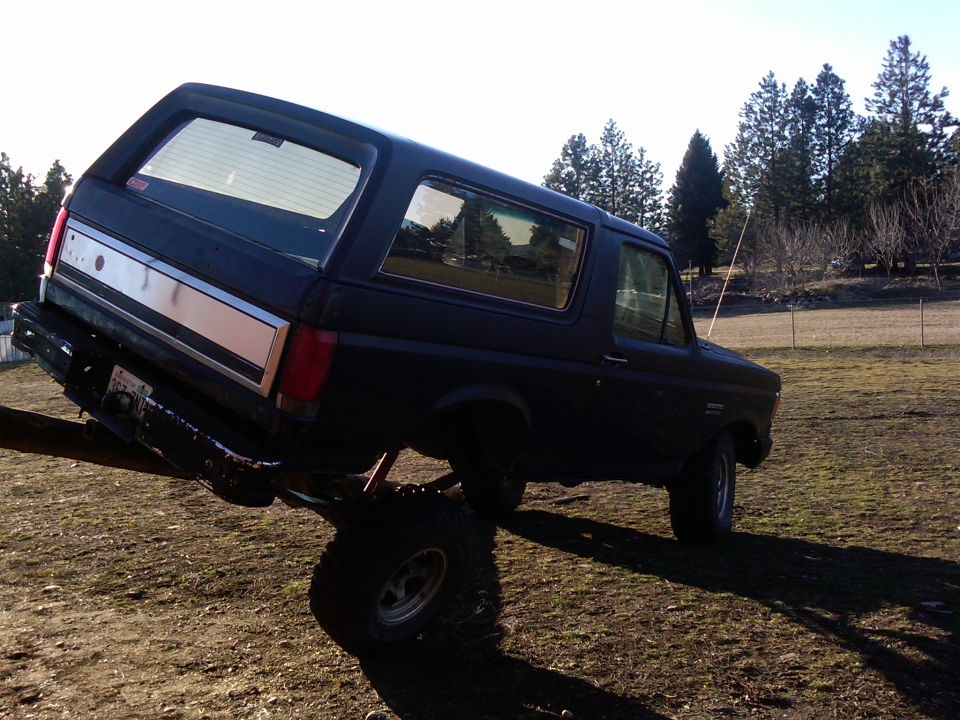 Dark blue 1988 Ford Bronco with silver stripe, angled view