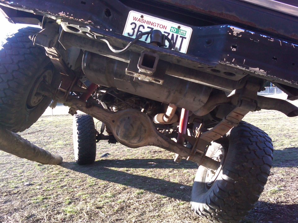 Rear suspension and axle of a lifted truck with a Washington license plate