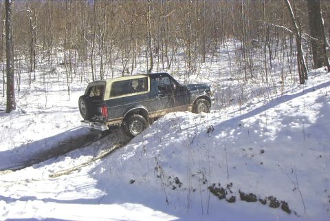 1995 Ford Bronco - A 1995 Ford Bronco navigates a snowy, wooded trail.