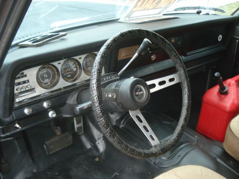 1977 Jeep Cherokee - The interior of a 1977 Jeep Cherokee shows its dashboard, gauges, and a red jerry can.