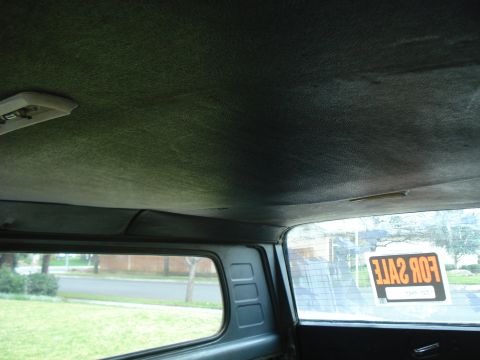 1977 Jeep Cherokee - The interior of a vehicle is shown, with a 'FOR SALE' sign visible in the rear window.