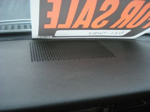 1977 Jeep Cherokee - Close-up of a dashboard speaker grille, with a 'FOR SALE' sign visible above.