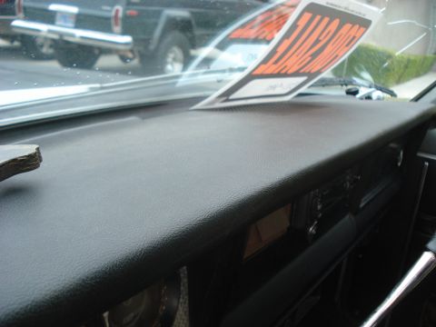 1977 Jeep Cherokee - A 'For Sale' sign is displayed on the windshield of a Jeep, with another Jeep visible in the background.