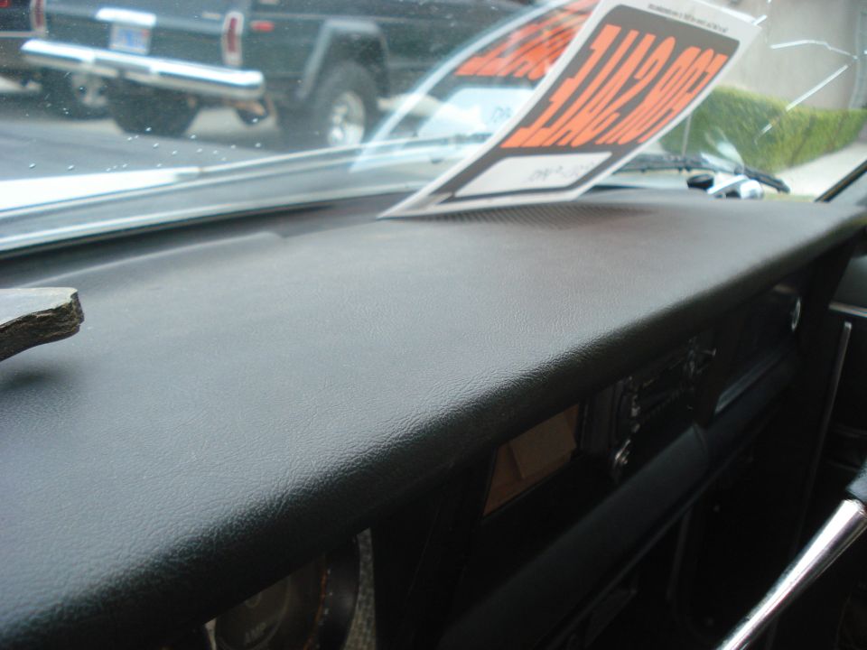 Dashboard view inside a Jeep, with a 'For Sale' sign on the windshield. Another Jeep is visible through the windshield