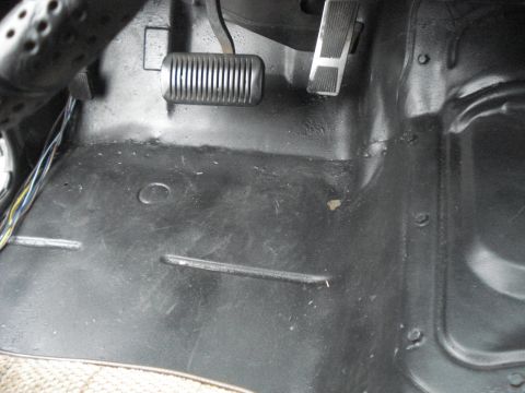 1977 Jeep Cherokee - Close-up view of the interior floor and pedals, showing the driver's footwell.